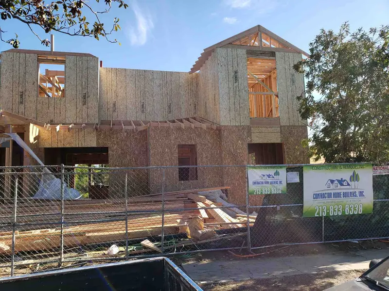 Two-story wall framing with the Contractor Home Builders banner